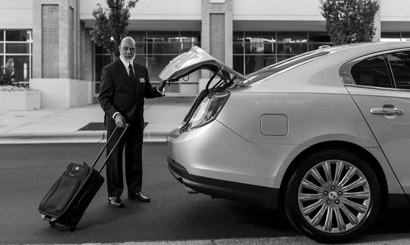Chauffeur loading luggage into the car